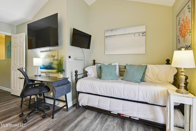 bedroom featuring wood-type flooring and vaulted ceiling