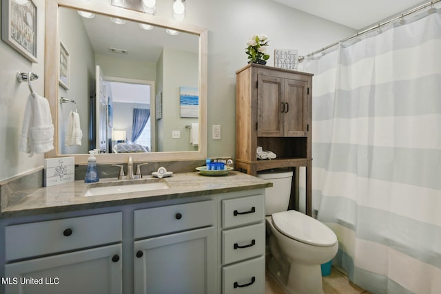 bathroom with vanity, toilet, and a shower with shower curtain