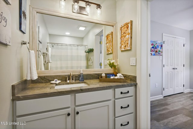 bathroom with vanity and hardwood / wood-style floors