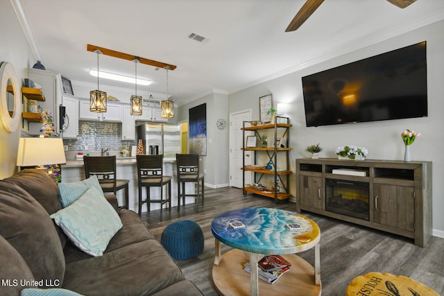 living room featuring ornamental molding and dark hardwood / wood-style flooring