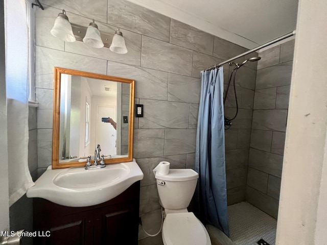 111 Thomas St, Cleveland, MS 38732 - bathroom with a shower stall, tile walls, vanity, and toilet