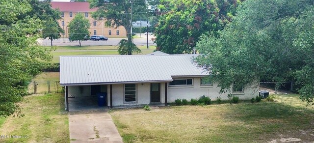 111 Thomas St, Cleveland, MS 38732 - view of front of home with metal roof, fence, concrete driveway, and a front yard