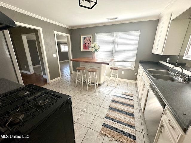 111 Thomas St, Cleveland, MS 38732 - kitchen featuring stainless steel dishwasher, ornamental molding, a sink, black range with gas stovetop, and dark countertops