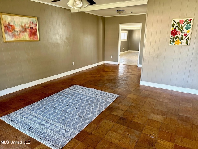 111 Thomas St, Cleveland, MS 38732 - empty room featuring wood walls, baseboards, a ceiling fan, and ornamental molding