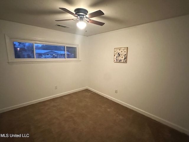111 Thomas St, Cleveland, MS 38732 - empty room featuring dark carpet, visible vents, baseboards, and ceiling fan