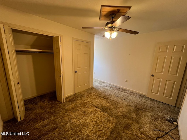 unfurnished bedroom featuring dark carpet, a closet, and ceiling fan