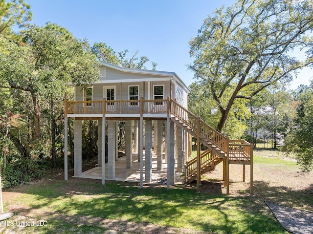 rear view of property featuring a patio and a lawn