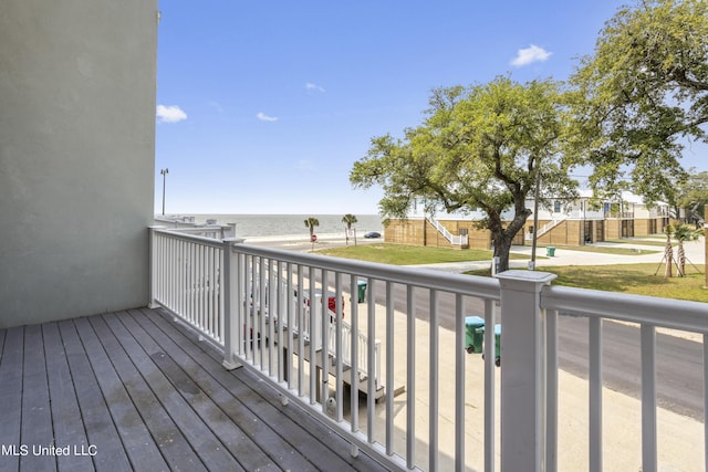 wooden terrace featuring a water view