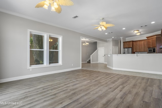 unfurnished living room with ornamental molding, ceiling fan with notable chandelier, and light wood-type flooring