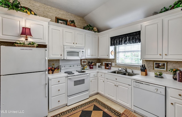814 Lynwood Ln, Pearl, MS 39208 - kitchen featuring white appliances, a sink, lofted ceiling, backsplash, and white cabinetry