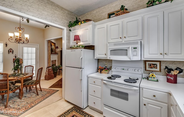 814 Lynwood Ln, Pearl, MS 39208 - kitchen featuring white appliances, white cabinets, a chandelier, light countertops, and wallpapered walls