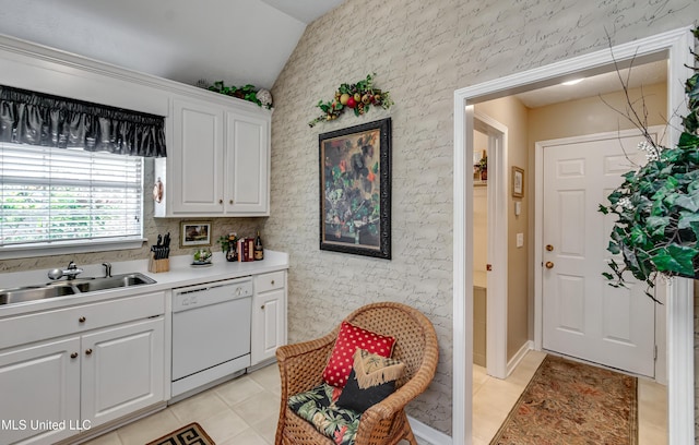 814 Lynwood Ln, Pearl, MS 39208 - kitchen with white dishwasher, a sink, vaulted ceiling, light tile patterned floors, and white cabinetry
