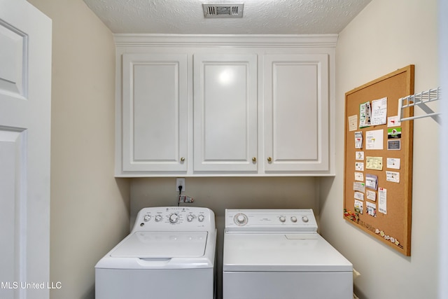 814 Lynwood Ln, Pearl, MS 39208 - washroom featuring washing machine and clothes dryer, cabinet space, and a textured ceiling