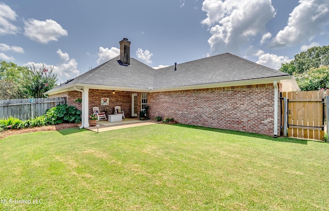 814 Lynwood Ln, Pearl, MS 39208 - back of property with brick siding, a patio, a chimney, and a shingled roof