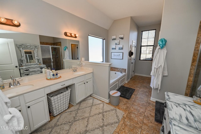 bathroom with vanity, tile patterned floors, vaulted ceiling, and separate shower and tub