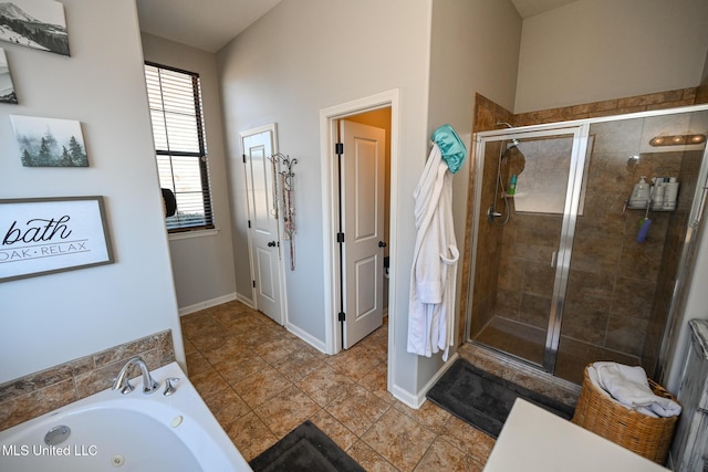 bathroom with tile patterned floors and shower with separate bathtub