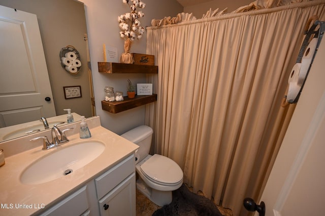 bathroom featuring toilet and vanity