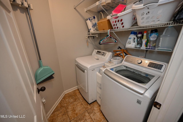 laundry area featuring light tile patterned floors and washer and clothes dryer