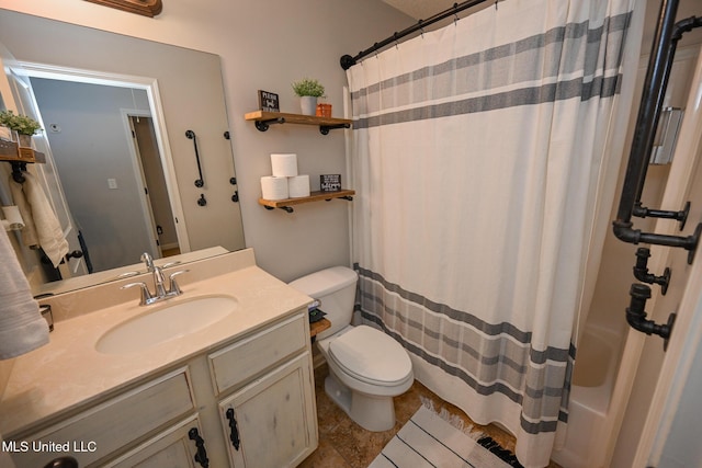 bathroom with toilet and vanity