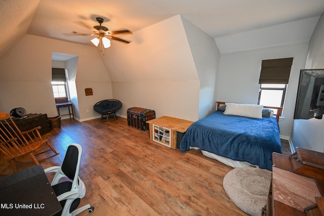 bedroom with vaulted ceiling, ceiling fan, and hardwood / wood-style flooring