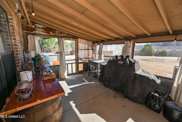 sunroom featuring vaulted ceiling