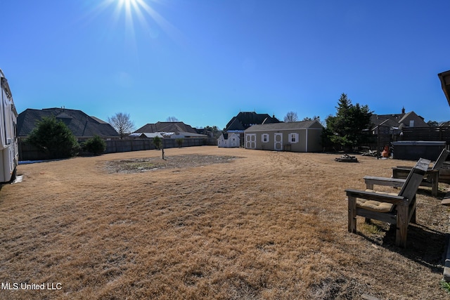 view of yard with an outdoor fire pit and an outdoor structure