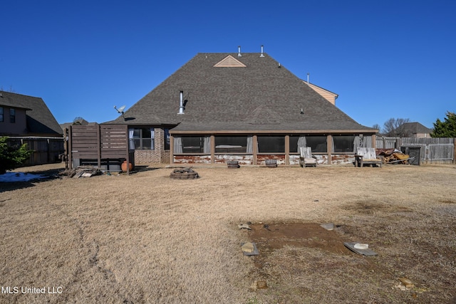 back of house featuring an outdoor fire pit