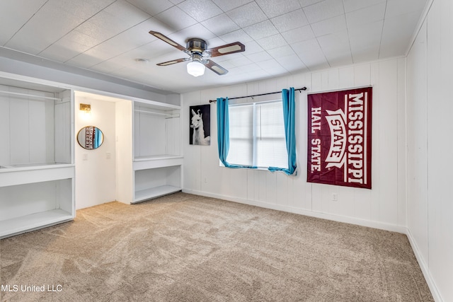 unfurnished room with ceiling fan and carpet flooring