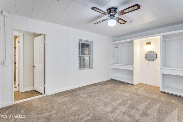 unfurnished bedroom with ceiling fan and light colored carpet