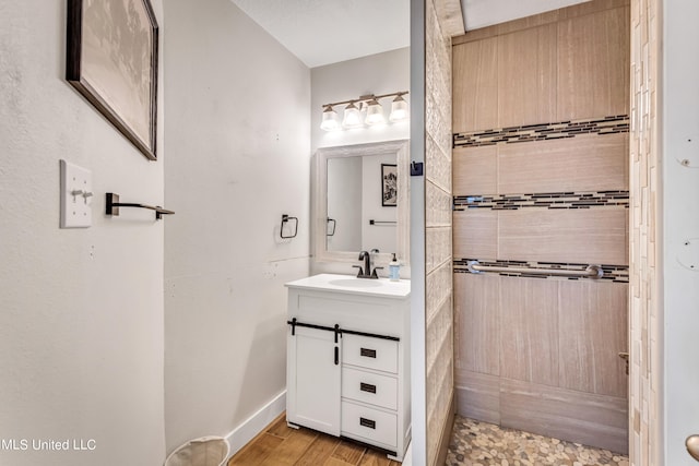 bathroom featuring vanity, hardwood / wood-style floors, and a shower