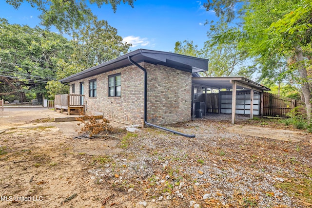 view of side of property featuring a deck and a carport