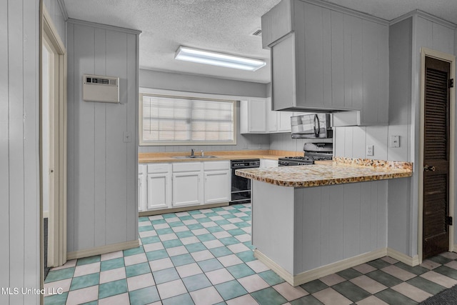 kitchen with sink, black appliances, white cabinetry, and a textured ceiling