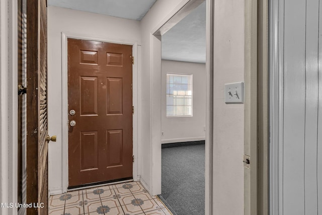 view of carpeted entrance foyer