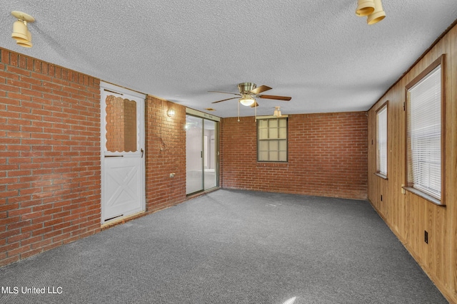 spare room featuring carpet and a textured ceiling