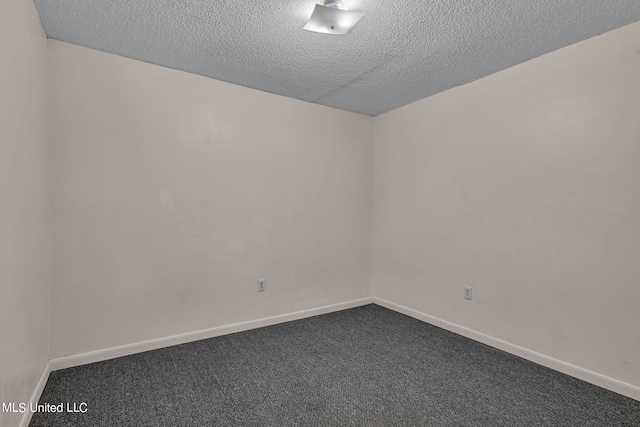 empty room with carpet flooring and a textured ceiling