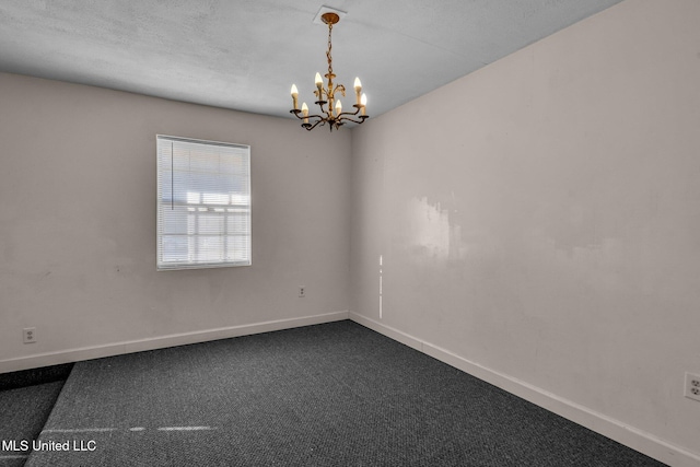 carpeted empty room featuring a chandelier