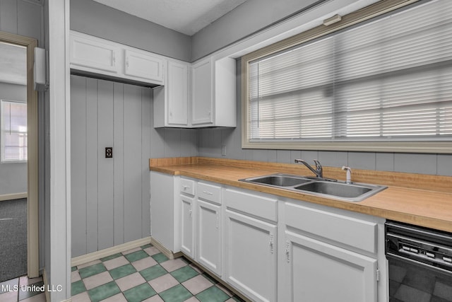 kitchen with white cabinets, sink, and a wealth of natural light