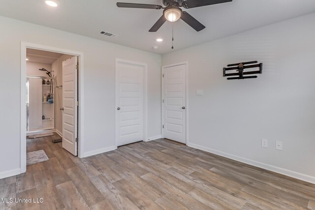 unfurnished bedroom with baseboards, light wood-style flooring, and visible vents