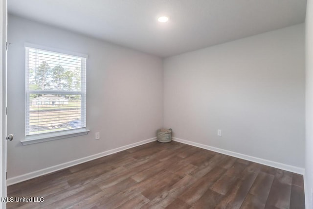 unfurnished room featuring recessed lighting, baseboards, plenty of natural light, and dark wood-type flooring