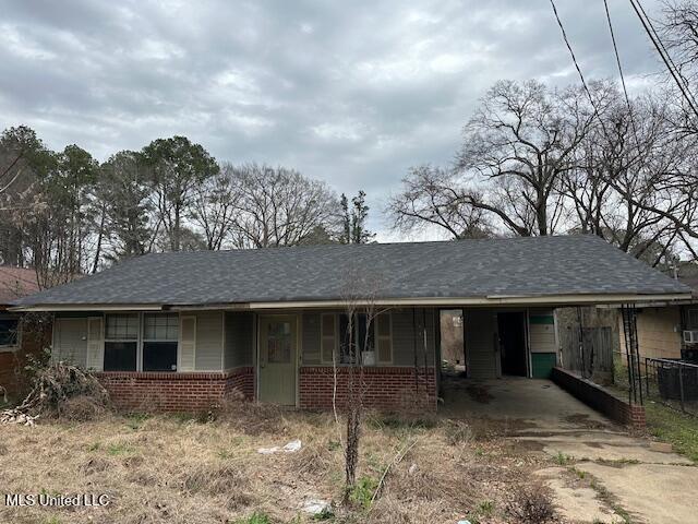 ranch-style home with brick siding and roof with shingles