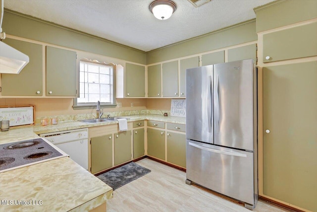 kitchen featuring dishwasher, stovetop, sink, stainless steel fridge, and a textured ceiling