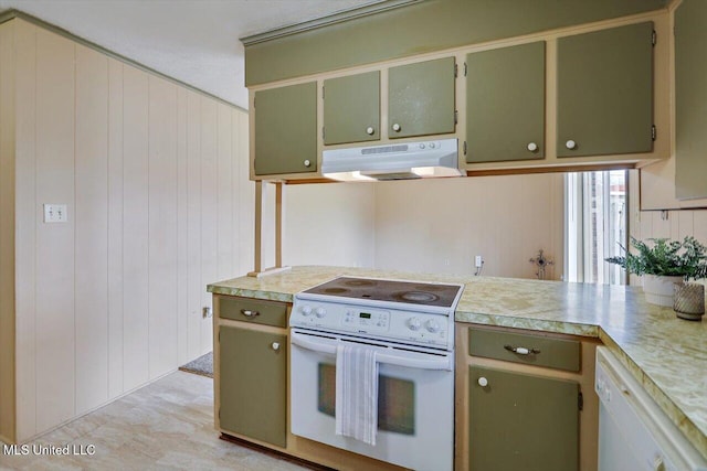 kitchen featuring white appliances, wooden walls, and green cabinetry