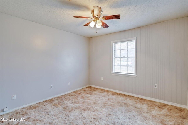 unfurnished room featuring light carpet, ceiling fan, and a textured ceiling