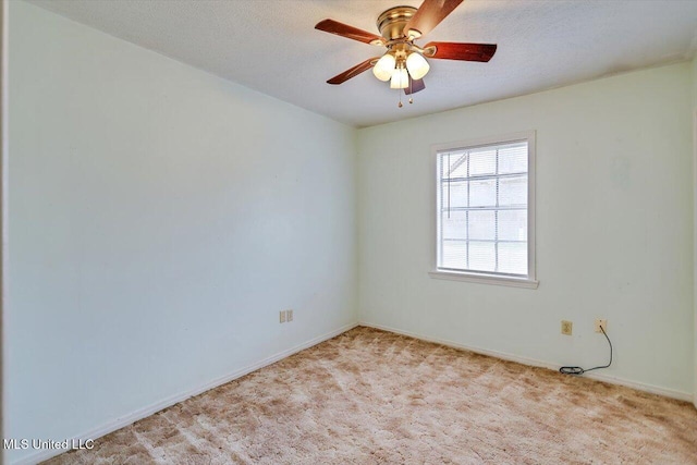 spare room featuring a textured ceiling, light colored carpet, and ceiling fan