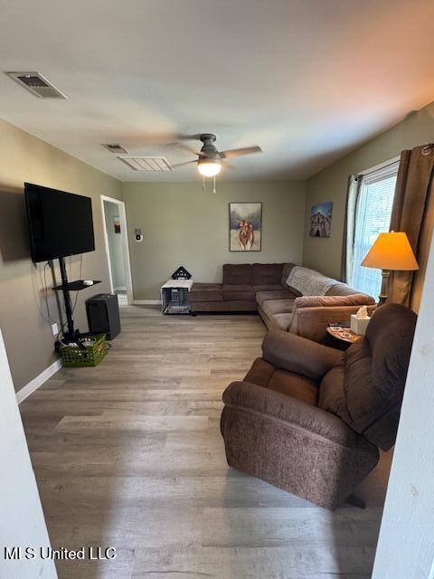 living room with ceiling fan and light wood-type flooring