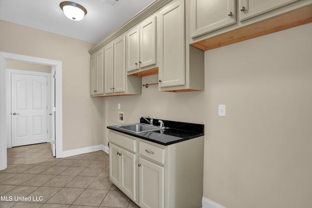 kitchen featuring light tile patterned floors and sink