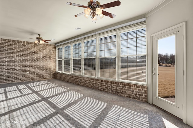 unfurnished sunroom with ceiling fan