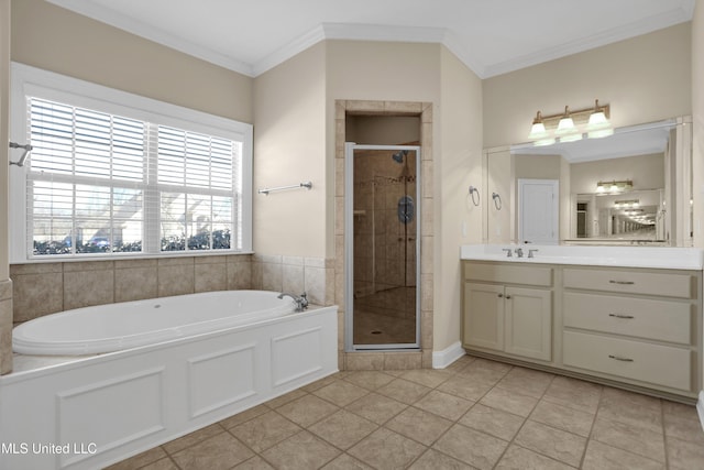 bathroom featuring plus walk in shower, tile patterned flooring, crown molding, and vanity