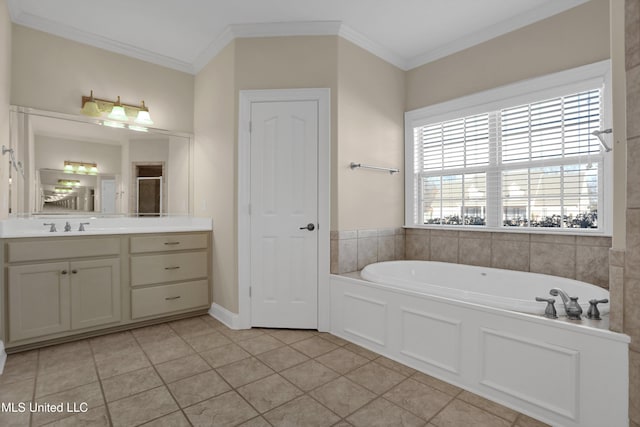 bathroom featuring ornamental molding, tile patterned floors, a tub to relax in, and vanity