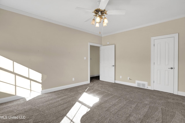 carpeted spare room with ceiling fan and crown molding